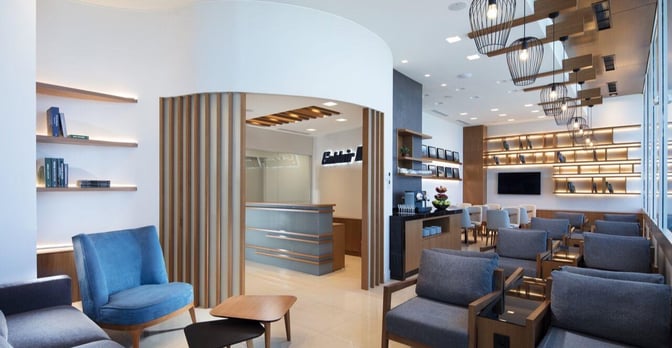 The Goldair Handling Lounge at Heraklion International Airport features comfortable seating, a reception desk, and a refreshment area with bookshelves.