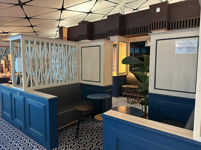 Booth seating in Hong Kong Airlines Lounge (Club Autus) provides semi-private spaces with small tables and decorative partitions.