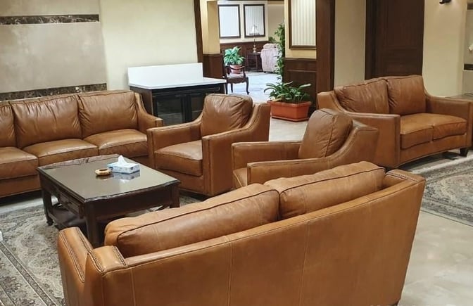 The seating area in Pearl Lounge at Hurghada International Airport features comfortable armchairs and sofas arranged around a central table.