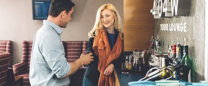 The Aspire Lounge at Inverness Airport features a bar area with a selection of spirits and seating for guests.