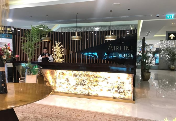 The entrance to the Airline Lounge at Islamabad International Airport features a reception desk with decorative elements and signage.