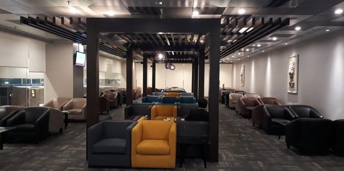 The seating area in the Islamabad International Airport lounge features rows of armchairs arranged for passenger comfort and relaxation.