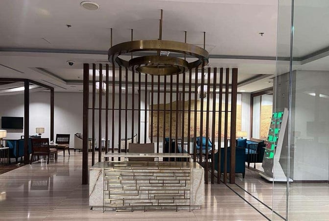 The entrance to the Domestic CIP Lounge at Islamabad International Airport features a reception desk and seating area visible through glass doors.