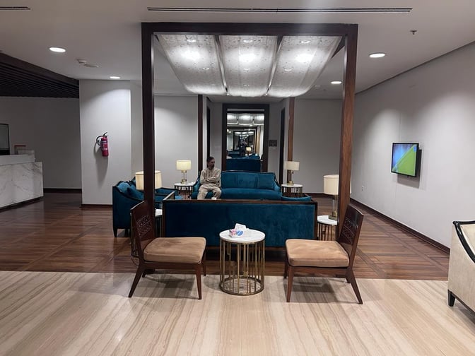 The seating area in the Domestic CIP Lounge at Islamabad International Airport features comfortable chairs, sofas, and small tables for relaxation.