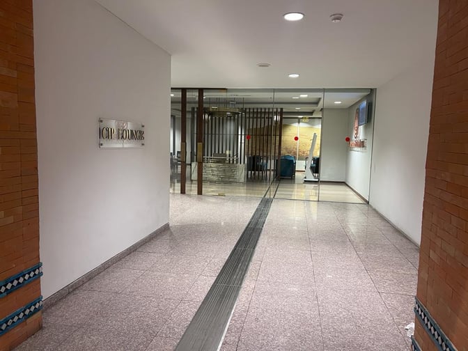 The entrance to the CIP Lounge at Islamabad International Airport features glass doors and a visible sign on the wall.