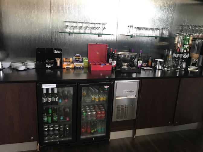 The Rendezvous Executive Lounge at Isle of Man Airport features a self-serve beverage station with a variety of drinks and snacks.