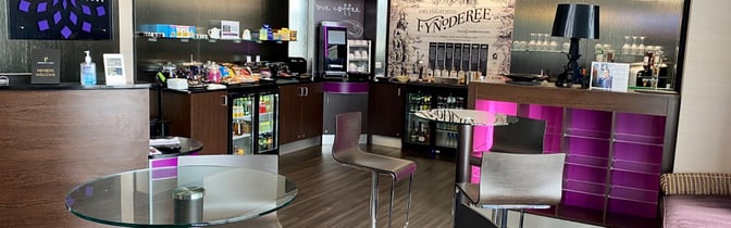 The Rendezvous Lounge at Isle of Man Airport offers a self-serve snack and beverage area with seating for travelers.