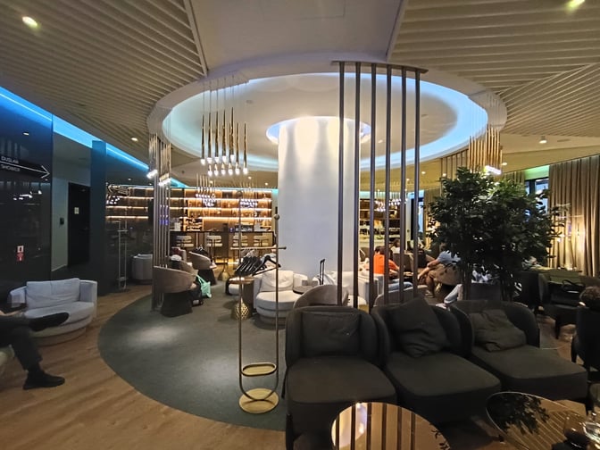 The Revolve Lounge at YotelAir Istanbul Airport features a seating area with comfortable chairs and a bar with high stools.
