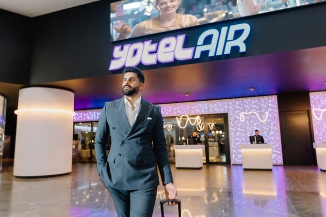 The entrance to YotelAir at Istanbul Airport features check-in counters and digital signage, located in the terminal area.