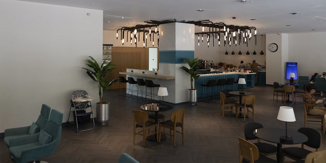 The Primeclass Lounge at Izmir Airport features a bar area with counter seating and a self-serve food station.