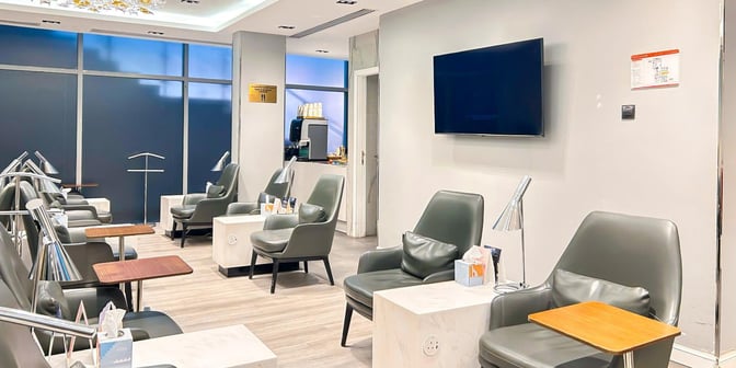 The seating area in Hayyak Lounge at King Abdullah bin Abdulaziz International Airport features comfortable chairs with individual tables and lamps.
