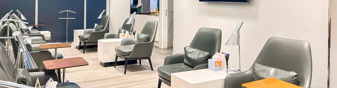 The seating area in Hayyak Lounge at King Abdullah bin Abdulaziz International Airport features comfortable chairs with side tables and lamps.