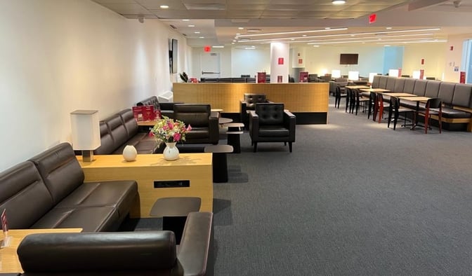 The HelloSky Lounge at JFK Airport features seating areas with sofas and tables, providing a comfortable space for travelers.