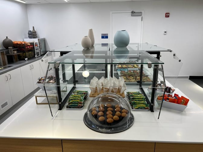 The HelloSky Lounge at JFK Airport features a self-serve snack station with muffins, granola bars, and assorted packaged snacks.