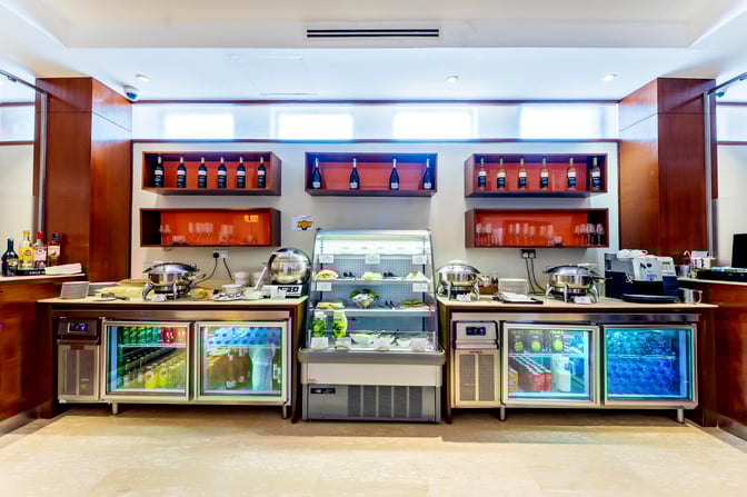 The Aspire Lounge at Jomo Kenyatta International Airport features a self-serve food and beverage station with hot dishes and refrigerated drinks.