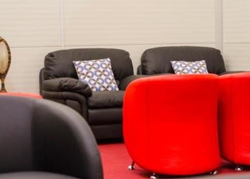 Seating in the Mount Kenya Lounge at Jomo Kenyatta International Airport includes cushioned chairs and sofas, providing comfortable waiting areas for travelers.