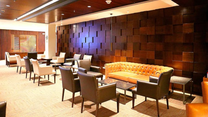 The Sumaq VIP Lounge at Jorge Chavez International Airport features a seating area with armchairs, sofas, and small tables for travelers.