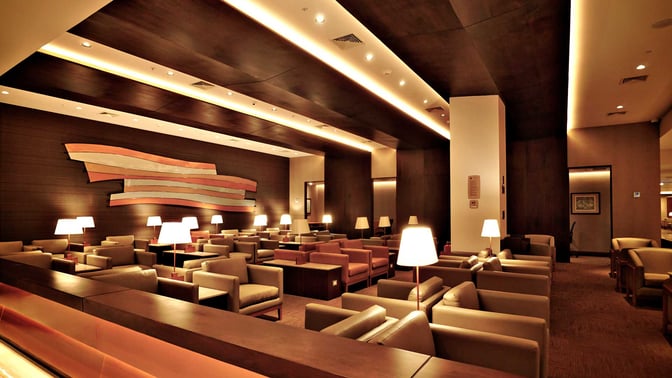 The Sumaq VIP Lounge at Jorge Chavez International Airport features a spacious seating area with armchairs and individual lamps for travelers.