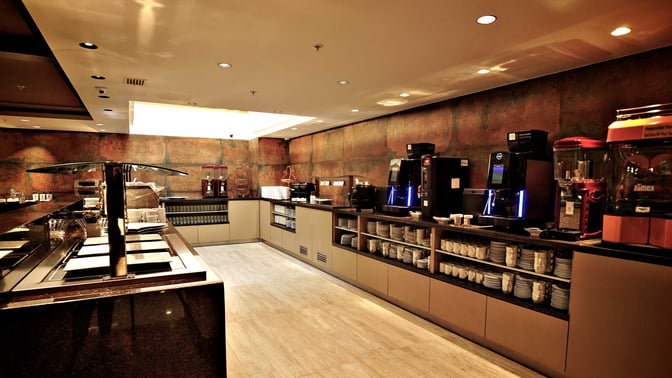 The Sumaq VIP Lounge at Jorge Chavez International Airport features a self-serve food and beverage area with coffee machines and dishware.