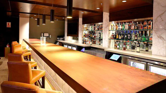 The Sumaq VIP Lounge bar at Jorge Chavez International Airport offers a variety of spirits with comfortable seating at the counter.