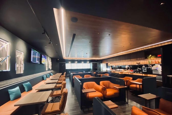 The Southern Premium Lounge at Kaohsiung International Airport features booth and table seating with a self-serve food and beverage area.