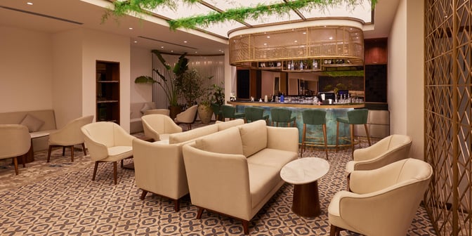 The 080 Arrivals Lounge at Kempegowda Bangalore International Airport features a bar area with seating and a comfortable lounge space.