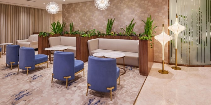 The 080 VIP Arrivals Lounge at Kempegowda Bangalore International Airport features comfortable seating with tables and decorative plants for relaxation.