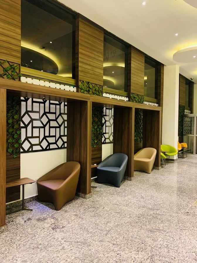 The Pearl Departures Lounge at Kigali International Airport features individual seating pods with small tables for personal use.