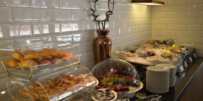 The Plaza Premium Lounge at King Abdulaziz International Airport features a self-serve food station with pastries, desserts, and fresh fruit.
