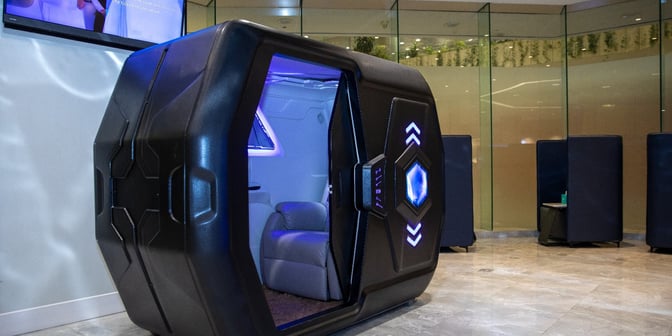 The Flynas Lounge at King Fahd International Airport features a futuristic sleeping pod with a reclining chair for passenger relaxation.