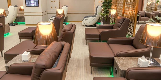 The Hayyak Lounge at King Khalid International Airport features comfortable seating with massage chairs and individual side tables for travelers.