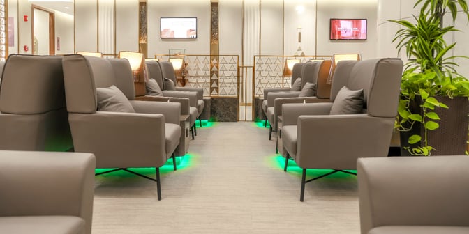 The seating area in Hayyak Lounge at King Khalid International Airport features comfortable armchairs arranged in rows with small tables.