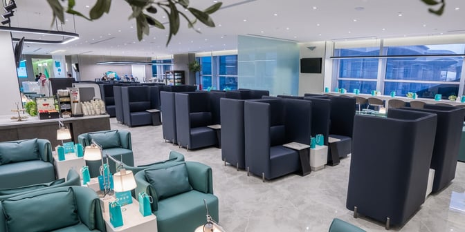 The Flynas Lounge at King Khalid International Airport features semi-private booth seating and a self-serve beverage station for travelers.