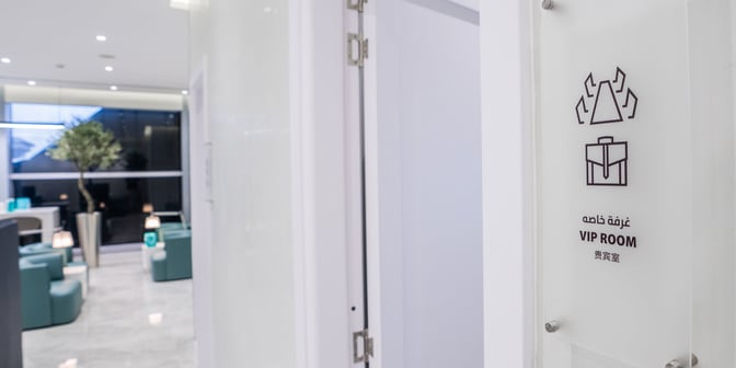 The Flynas Lounge at King Khalid International Airport features a VIP room entrance with visible seating and decorative plants inside.