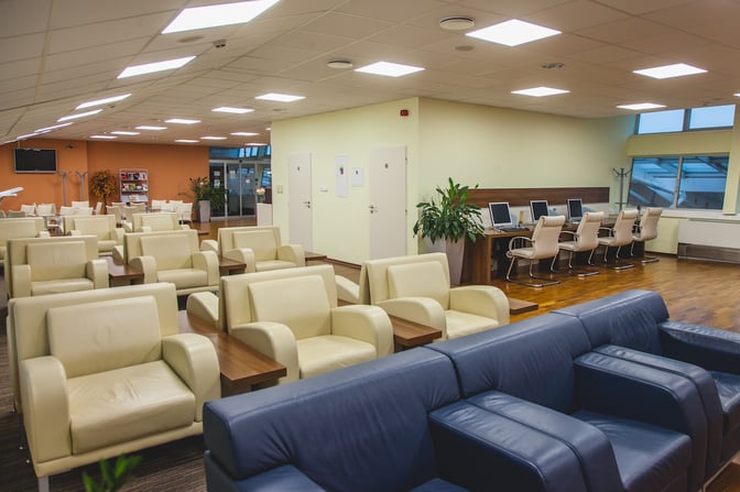 The Kosice Business Lounge features comfortable seating and a work area with computers, providing a relaxing space for travelers.