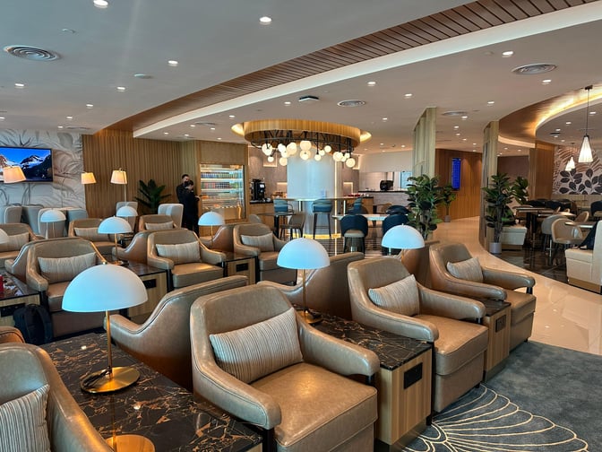 The Travel Club Lounge at Kota Kinabalu International Airport features comfortable seating, a beverage station, and a dining area for travelers.