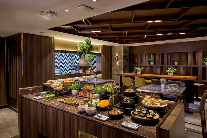 The Plaza Premium First lounge at Kuala Lumpur International Airport features a self-serve buffet with a variety of fresh salads and snacks.