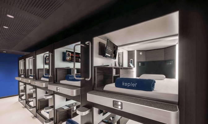 The Kepler Club at Kuala Lumpur International Airport features individual sleeping pods equipped with bedding, personal screens, and storage space.