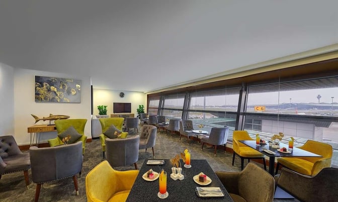 The Sky Suite Airport Lounge at Kuala Lumpur International Airport features comfortable seating with views of the airport runway.