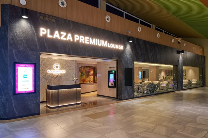 The entrance to Plaza Premium Lounge at Langkawi International Airport features a reception desk and self-check-in kiosk.