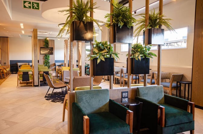 The Bidvest Premier Lounge at Lanseria International Airport features varied seating options with plants dividing spaces for a relaxed atmosphere.