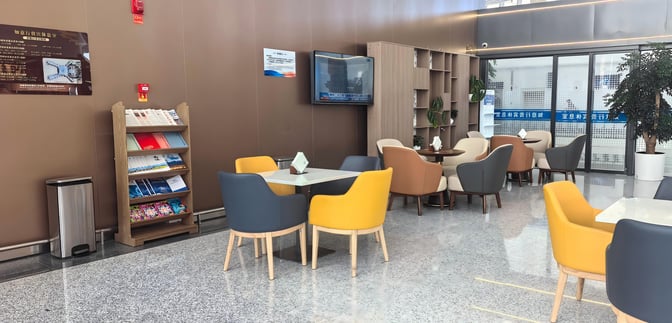 The T3 VIP Lounge at Lanzhou Zhongchuan Airport features a seating area with tables, chairs, a TV, and a magazine rack.