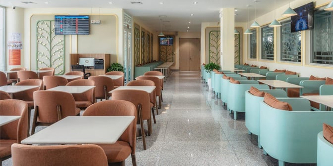The SH Premium Lounge at Lien Khuong International Airport features spacious seating with tables and flight information displays.