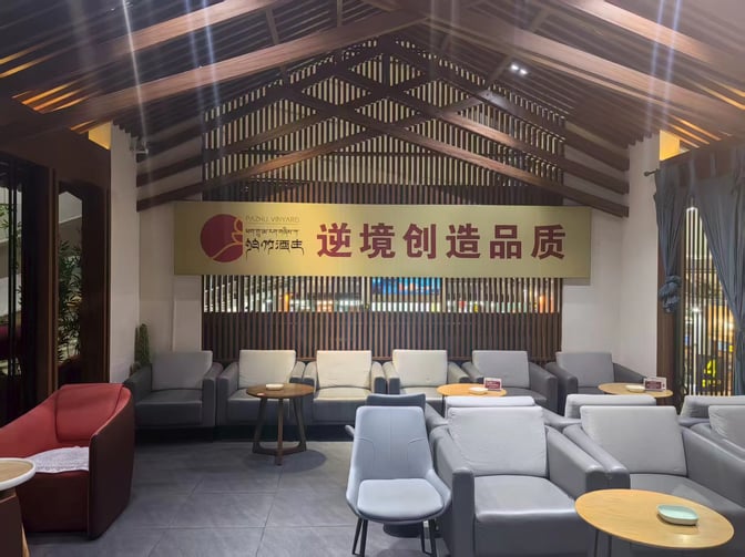 The seating area in the VIP Lounge at Lijiang Sanyi Airport features comfortable armchairs and small tables for passenger relaxation.