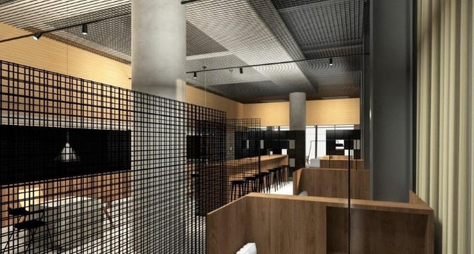 The business lounge at Ljubljana Airport features semi-private seating areas with partitioned booths and a central high-top table for guests.