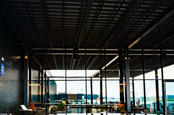 The outdoor seating area at Ljubljana Airport's business lounge offers tables and chairs with views of the tarmac.