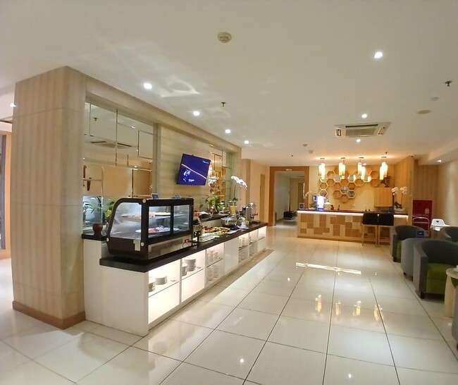 The Concordia Lounge at Lombok International Airport features a self-serve food area with a variety of snacks and beverages.