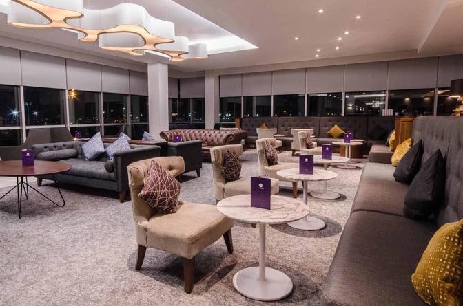 The No1 Lounge at London Gatwick Airport features a spacious seating area with comfortable chairs, sofas, and small tables.