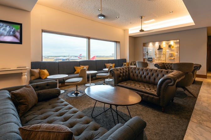 The No1 Lounge at London Heathrow Airport features comfortable seating with views of the runway, offering a relaxing space for travelers.