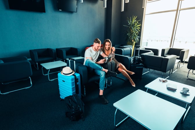 The seating area in Lublin Airport's Business Executive Lounge features comfortable chairs and tables, with large windows providing natural light.